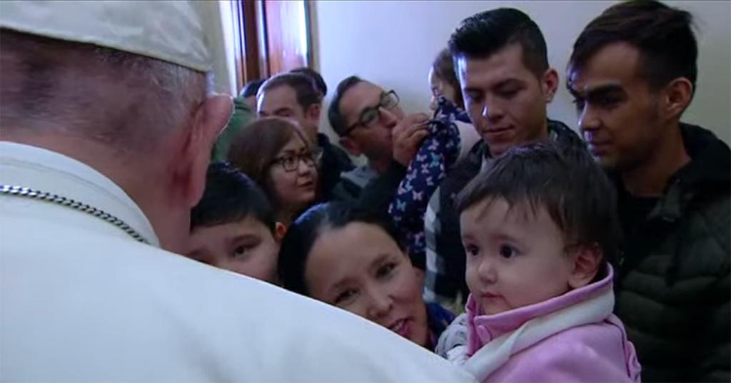 Pope Francis and the refugees from Lesbos unveiling the cross of migrants: